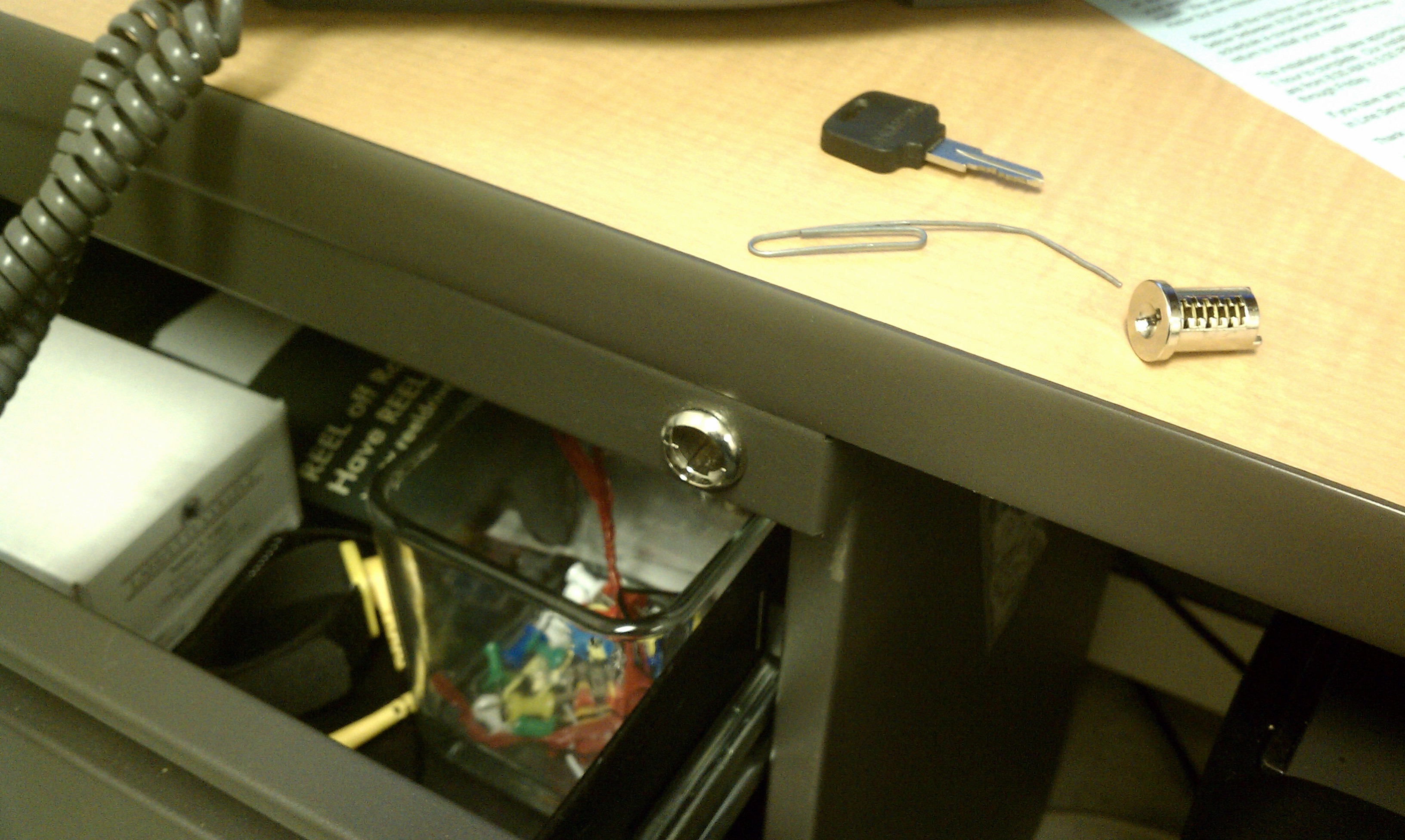 Dismantling a desk drawer lock with a paper clip. - Undrblog